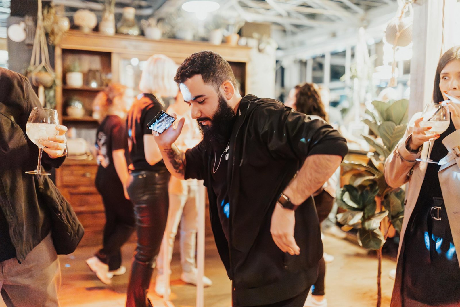 Vibrant indoor party scene with people dancing and enjoying drinks.